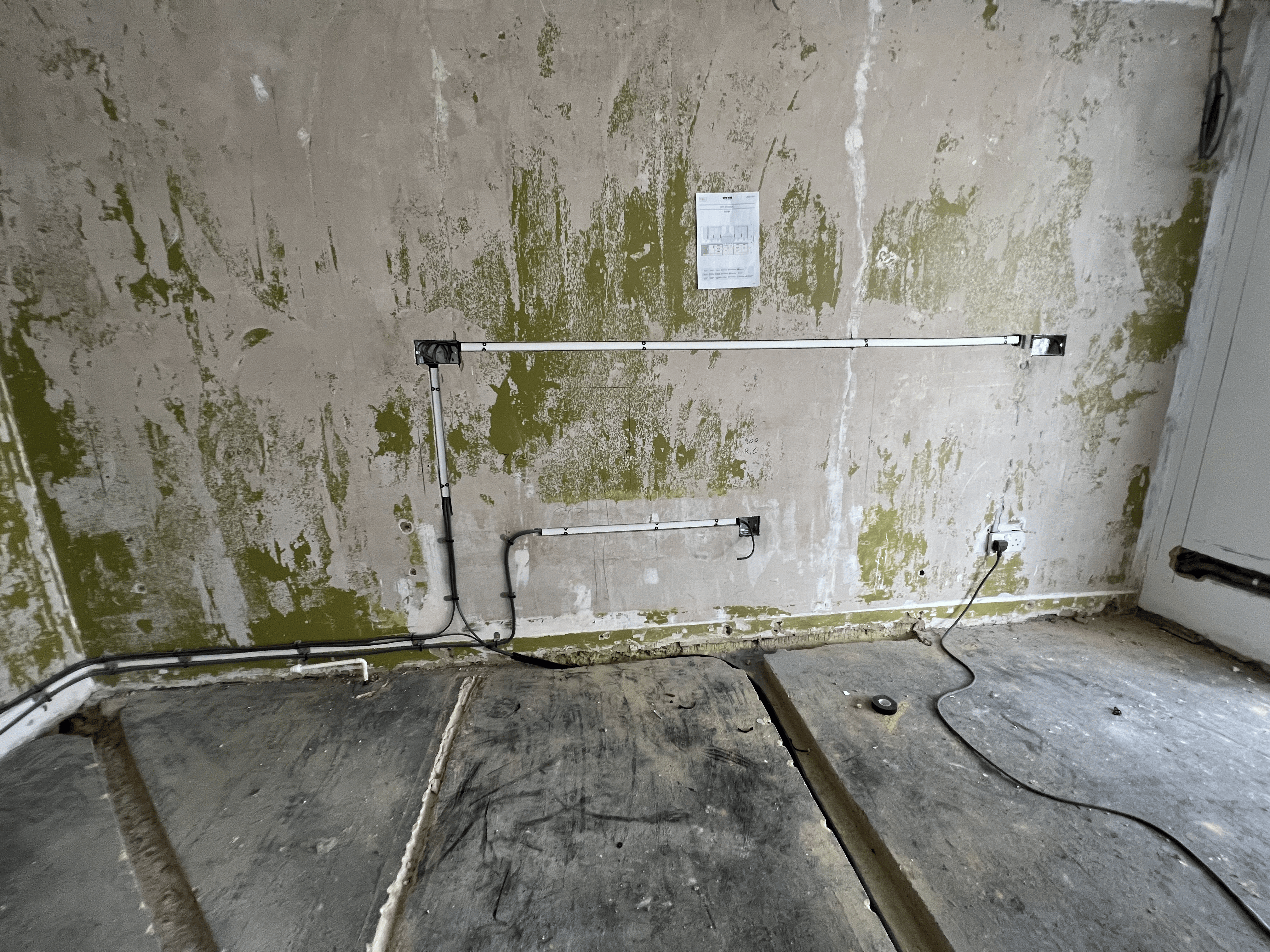 Wall stripped back with new cable runs installed during a full house rewire